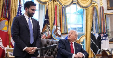 Donald Trump looks up from his Oval Office desk at Zohran Mamdani