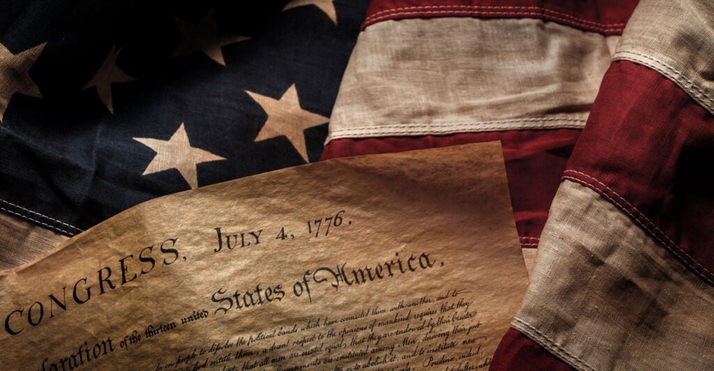 Declaration of Independence laid upon an American flag.