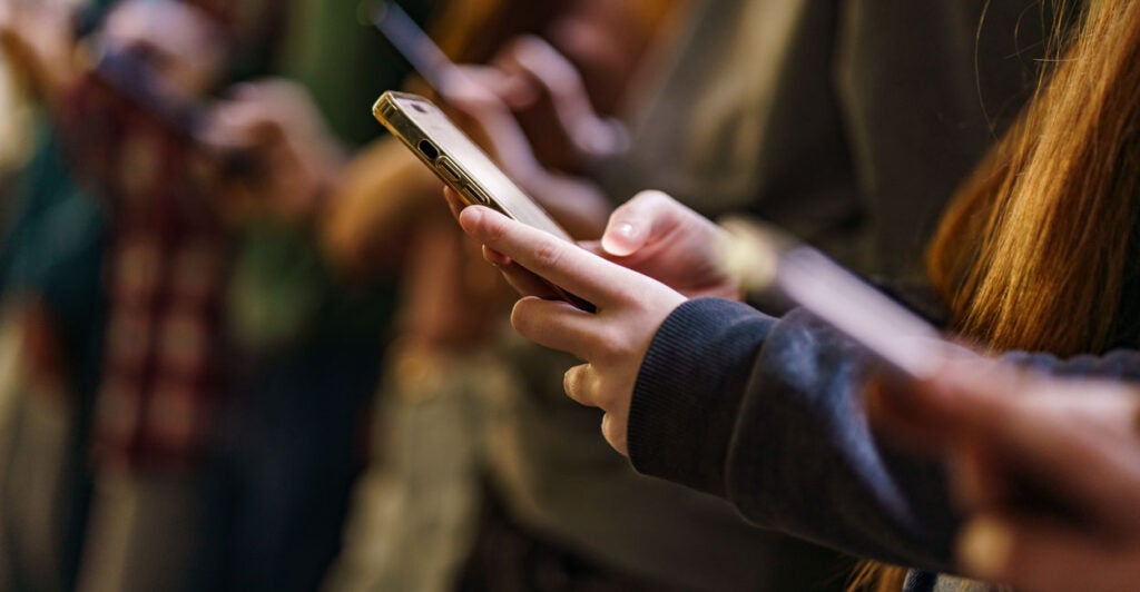 Close-up of mobile phones in children's hands in the school.