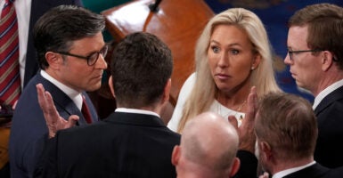 Speaker of the House Mike Johnson, R-La, and Rep. Marjorie Tayler Greene, R-Ga., talk with fellow Representatives.