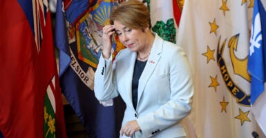 Governor Maura Healey walks into the Northeast Governors and Canadian Premiers moderated discussion at the State House Library.