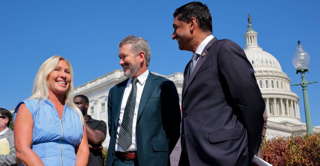 Rep. Marjorie Taylor Greene, R-Ga., speaks with Rep. Thomas Massie, R-Ky., and Rep. Ro Khanna, D-Calif., during a news conference.