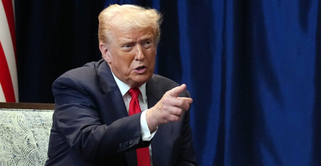 President Donald Trump pointing with right hand.