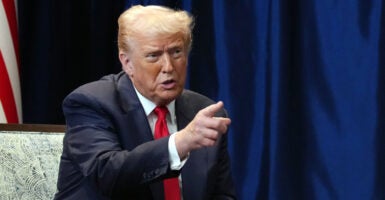 President Donald Trump pointing with right hand.