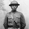 Harry Truman stands in military uniform during the first world war.