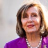 Nancy Pelosi, wearing a sport coat, smiles outside.