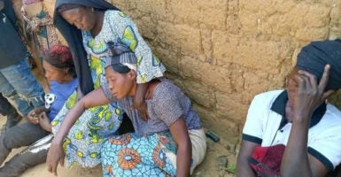 Nigerians sit together and comfort one another following a recent attack on Christians.