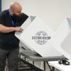A Travis County, Texas, election technician sets up voting machines.