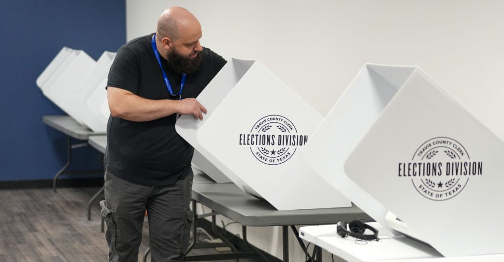 A Travis County, Texas, election technician sets up voting machines.