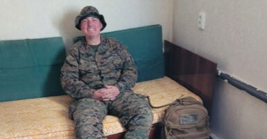 Marine vet Thomas Harris in uniform, seated and smiling.
