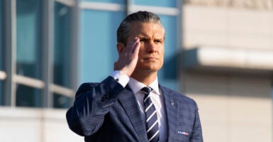 U.S. War Secretary Pete Hegseth salutes as he inspect a guard of honor