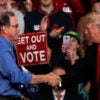 President Donald Trump shakes hands with Mike Braun during a campaign rall.