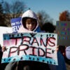 Child holding a sign that says "trans pride" at the Supreme Court.