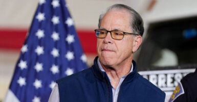 Indiana Gov. Mike Braun in blue vest jacket speaks at press conference.