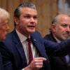 Pete Hegseth, with Donald Trump at his right and Howard Lutnick to his left points during a cabinet meeting.
