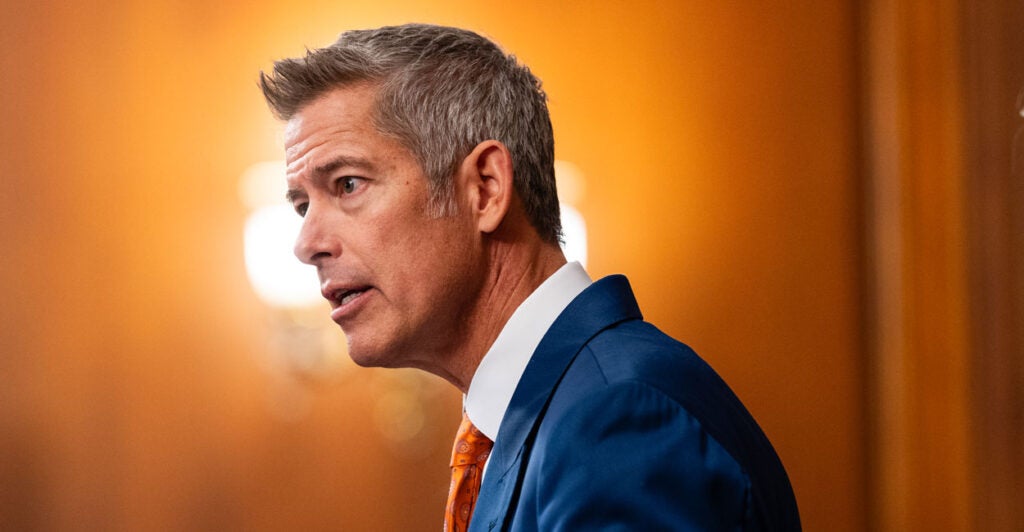 Profile of Sean Duffy against an orange background.