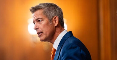 Profile of Sean Duffy against an orange background.