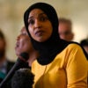 Ilhan Omar in a yellow blouse.