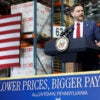 JD Vance speaks at a podium above sign reading "Lower Prices, Bigger Pay."