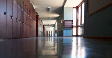 A look down an empty school hallway lined with lockers.
