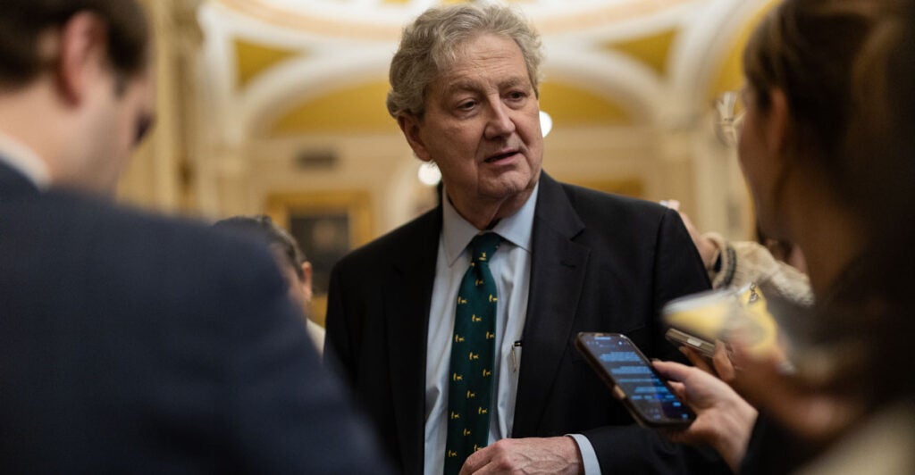 Sen. John Kennedy talks to reporters in a U.S. Capitol hallway.