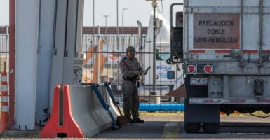 A Texas Department of Public Safety trooper inspects a commercial truck at a border crossing.
