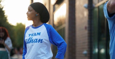 Ihan Omar in a blue-sleeved jersey reading 