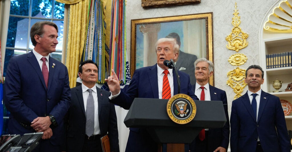 Donald Trump, Dr. Mehmet Oz and other officials in Oval Office.