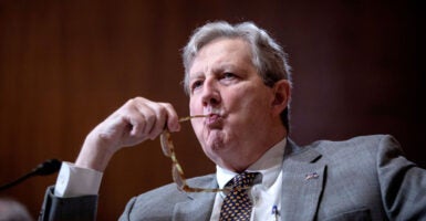 Sen. John Kennedy chews on the end of his eyeglasses during a hearing.