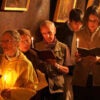 Christian pilgrims holding candles stand and pray inside Grotto where Jesus is believed to have been born.