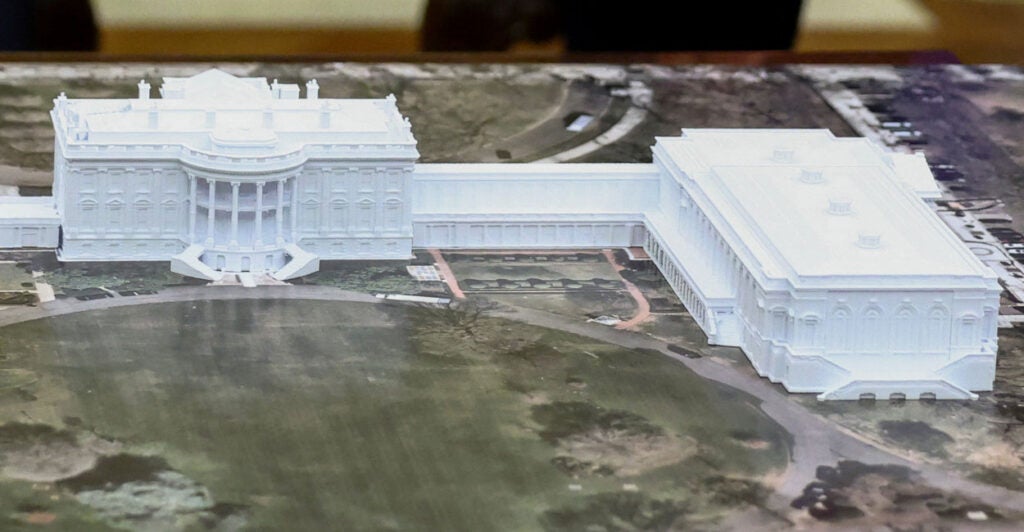 An overhead view of a model of the White House with new ballroom.