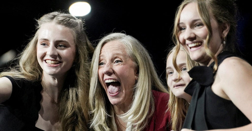 A laughing Abigail Spanberger, flanked by her three daughters.