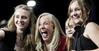 A laughing Abigail Spanberger, flanked by her three daughters.