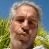 Close-up of Jeffrey Epstein, with pursed lips.