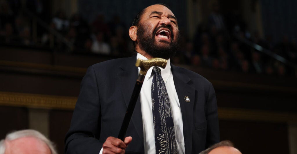 Al Green waves his cane in the House of Representatives.