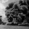 The USS Arizona burning furiously in Pearl Harbour (Pearl Harbor) after the Japanese attack. To the left of her are USS Tennessee and the sunken USS West Virginia. (Photo by Hulton Archive/Getty Images)