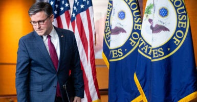 Mike Johnson enters the House press conference studio.