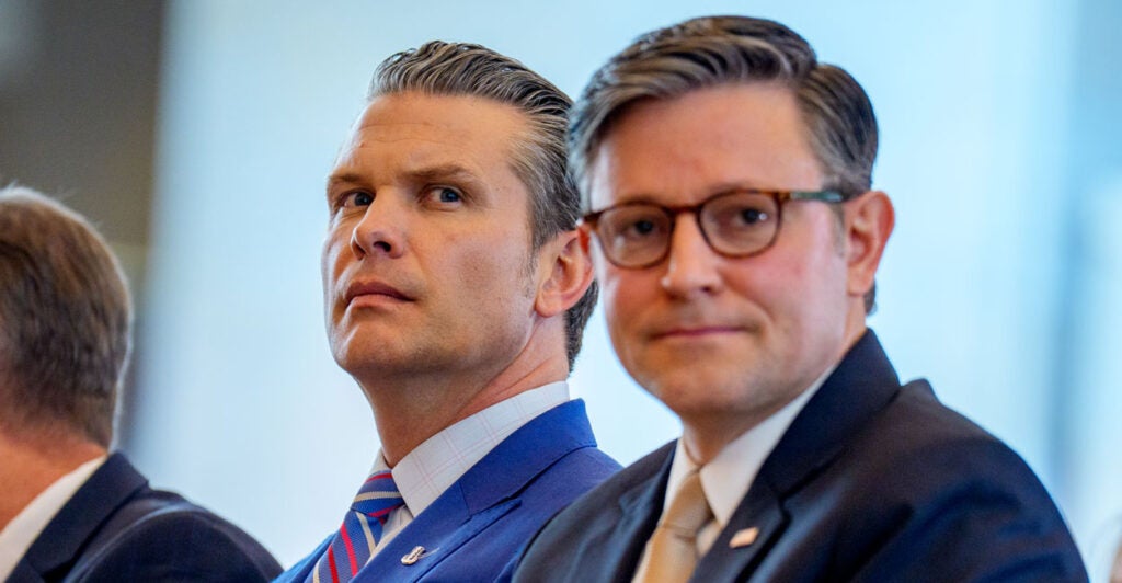 Secretary of War Pete Hegseth and Speaker of the House Mike Johnson sit together in the Capitol.