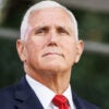 Mike Pence stands outside in a suit and tie.