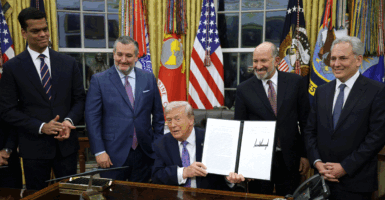 WASHINGTON, DC - DECEMBER 11: U.S. President Donald Trump displays a signed executive order as (2nd L-R) U.S. Sen. Ted Cruz (R-TX), Commerce Secretary Howard Lutnick and White House artificial intelligence (AI) and crypto czar David Sacks look on in the Oval Office of the White House on December 11, 2025 in Washington, DC. The executive order curbs states' ability to regulate artificial intelligence, something for which the tech industry has been lobbying.