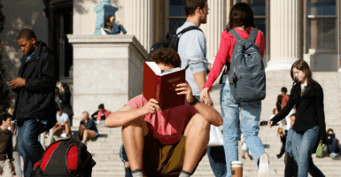 A student reads on the campus of Columbia University in New York, October 5, 2009. REUTERS/Mike Segar