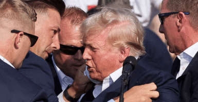Republican presidential candidate and former U.S. President Donald Trump is assisted by guards during a campaign rally at the Butler Farm Show in Butler, Pennsylvania, U.S., July 13, 2024. REUTERS/Brendan McDermid