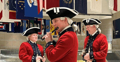 A member of the U.S. Army Old Guard Fife and Drum Corps rehearses off-stage before a performance at an event unveiling semiquincentennial coin designs, The ceremony was held Dec. 10 at the National Constitution Center in Philadelphia.