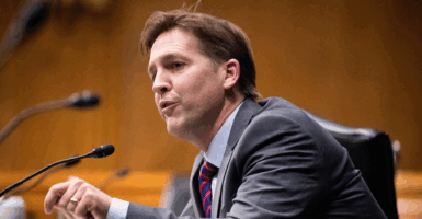 FILE PHOTO: Republican Senator of Nebraska Ben Sasse directs a question toward Xavier Becerra during the Senate Finance Committee hearing on Becerra's nomination to be secretary of Health and Human Services, on Capitol Hill in Washington, DC, U.S., February 24, 2021. Michael Reynolds/Pool via REUTERS/File Photo