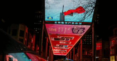 A giant screen shows a news report on patrol and law?enforcement operation drills around Taiwan conducted by China's Fujian Coast Guard, in Beijing, China December 30, 2025. REUTERS/Tingshu Wang