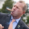 Congressman Troy Nehls smokes a cigar in front of the capitol.
