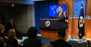 Marco Rubio behind a podium speaks to reporters.