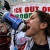 WASHINGTON, DC - JANUARY 11: An activist shouts slogans as she participates in a protest outside the headquarters of U.S. Immigration and Customs Enforcement (ICE) on January 11, 2026 in Washington, DC. Protests have broken out across the nation over the Trump administration’s recent actions in Venezuela and the shooting death last week of Renee Good by an Immigration and Customs Enforcement (ICE) officer in Minneapolis, Minnesota. (Photo by Alex Wong/Getty Images)
