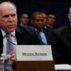 Then-Director of National Intelligence James Clapper watches then-CIA Director John Brennan speaks during a congressional hearing.