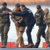 Nicholas Maduro and his wife are led away in handcuffs from a helicopter by DEA agents
